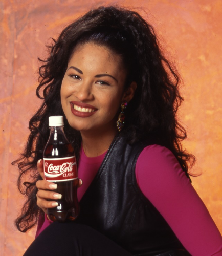 Selena posing with Coke bottle